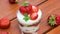 Cake in cup, classic vanilla sponge cake with cottage cheese cream and strawberries Trifle