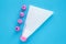 Cake decorating tools on blue background. White pastry bag with pink plastic nozzles for decoration baking