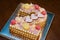 A cake in the form of two figures. Number two Biscuit cake. Birthday cake with pink hearts, macaroni and bezye. Cake for a girl