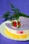 Cake with lavender, a mousse dessert with an exotic taste on a white plate on a purple background