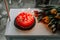 Cake with lighted candles, next to a bouquet of tulips