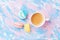 Cake macaron or macaroon and cup of coffee on colorful table top view. Flat lay. Creative breakfast for Woman day. Punchy pastel.