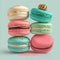Cake macaron or macaroon stack on turquoise background, colorful mint and pink almond cookies, pastel colors