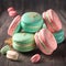 Cake macaron or macaroon stack on wooden table, colorful mint and pink almond cookies, pastel colors