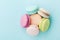 Cake macaron or macaroon on turquoise background from above, almond cookies, pastel colors