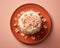 a cake with pink flowers on top of an orange plate