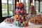 cake pop tower overflowing with colorful cake pops, with cascading ribbon and bow