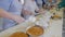 Cake production process. Workers produce cakes on conveyor.