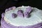 Cake with purble butter cream waiting for the confectioner to use the spatula.