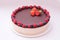 Cake souffle, covered with chocolate, jewelry, berries, raspberry, blueberry, blueberry, strawberry, white background