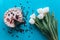 Cake, tulips and coffee on blue background