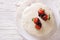 cake with white icing and strawberries in chocolate closeup. horizontal top view