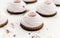 Cake, white-pink marshmallows, jam, cookies, chocolate on a blackboard, light background. Close-up