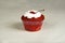 Cakecup red fruit cake with whipped cream with party candy