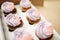 Cakes with biscuit cream on parchment paper sheet