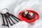 Cakes made of chocolate on a red plate on a white background. Cakes decorated with red jelly and delicate white cream. The metal k