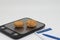 Cakes and pastries with cream lie on electronic kitchen scales, calorie counting and weight control, extra calories and