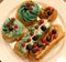 Cakes on a plate - cupcakes and eclairs, close up