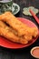 Cakwe Cakue or Chinese Oil Bread  Stick is Indonesian Traditional Food for Breakfast Served in Ceramic Plate on Wooden Table. In