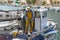 Cala Figuera, Mallorca, Spain - 05.02.2022: Fisherman in yellow fishing suit on a boat untangling fishing net