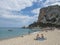 Cala Gonone, Sardinia, Italy, September 9: Cala Luna beach with sunbathing people and tourist ship boat. White sand