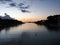 Cala santandria in ciutadella at twilight with a glowing evening sky reflected in dark calm water