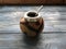 Calabash and mate bombilla on wooden background