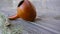 Calabash or pumpkin, metal straw and scattered yerba mate leaves on a wooden table