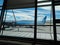 Calafate, Argentina. January 16 2019. Window in the Airport with a visible plane, lake and mountains. Concept of travel, holidays