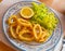 Calamari in a batter of tempera flour and fresh salad with lemon