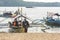 Calayo, Batangas, Philippines - A boatman pushes a small boat carrying domestic tourists off the beach. Slow recovery of