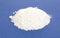 Calcium citrate powder on blue background.