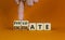 Calculate or evaluate symbol. Businessman turns wooden cubes and changes the word `evaluate` to `calculate`. Beautiful orange