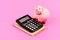 Calculate profit. Piggy bank pink pig and calculator. Finance manager job position. Economics and finance. Trading