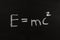 The calculation for mass energy equivalence ist standing on a chalkboard, physic formular