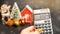 Calculator 2024, Christmas tree and miniature houses.