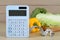 Calculator and food products on wooden table. Weight loss concept