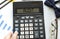 A calculator labeled AUDIT lies on financial documents in the office. Business concept