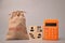Calculator, money bag and wooden blocks with payroll icons
