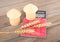 Calculator and paper granary and three ripe wheat ears on wooden board background