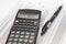 Calculator and pen on cash financial spreadsheet