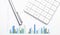 Calculator with pen on financial data. Concept of Business and Finance research