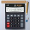 Calculator, pencil, eraser and ruler on blank sheet of paper wit