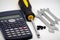 Calculator and screwdrivers isolated on the white background, close-up