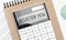 Calculator with text register now with craft colored notepad pen and financial documents
