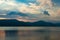 Caldera lake on dusk with mountain silhouettes on the background