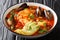 Caldo De Mariscos Recipe seafood soup with cod, shrimp, mussels, vegetables and avocado close-up in a bowl. Horizontal