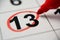 The calendar 13th of the month is circled. A red marker circles the thirteenth day of the month from the paper calendar