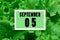 Calendar date oncalendar date on the background of green lettuce leaves.  September 5 is the fifth  day of the month