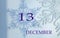 Calendar for December 13: the name of the month in English, the number 13 on a blue background of snowflakes and their shadows